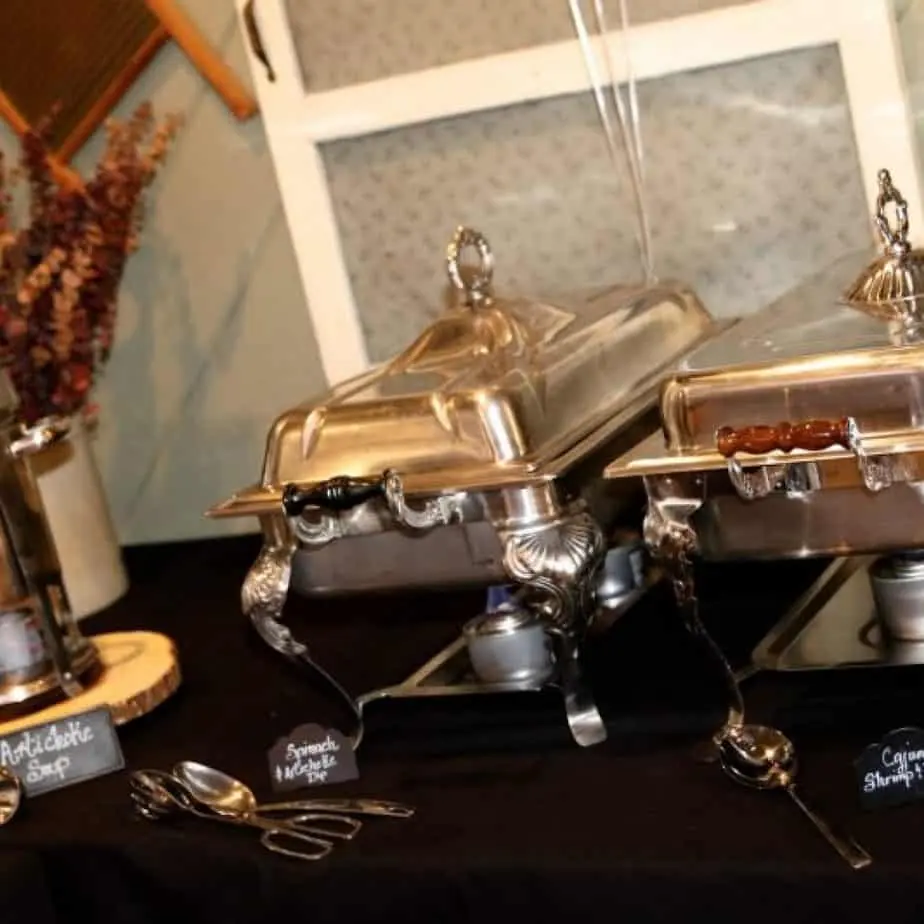Silver chafing dishes set up for a catered event