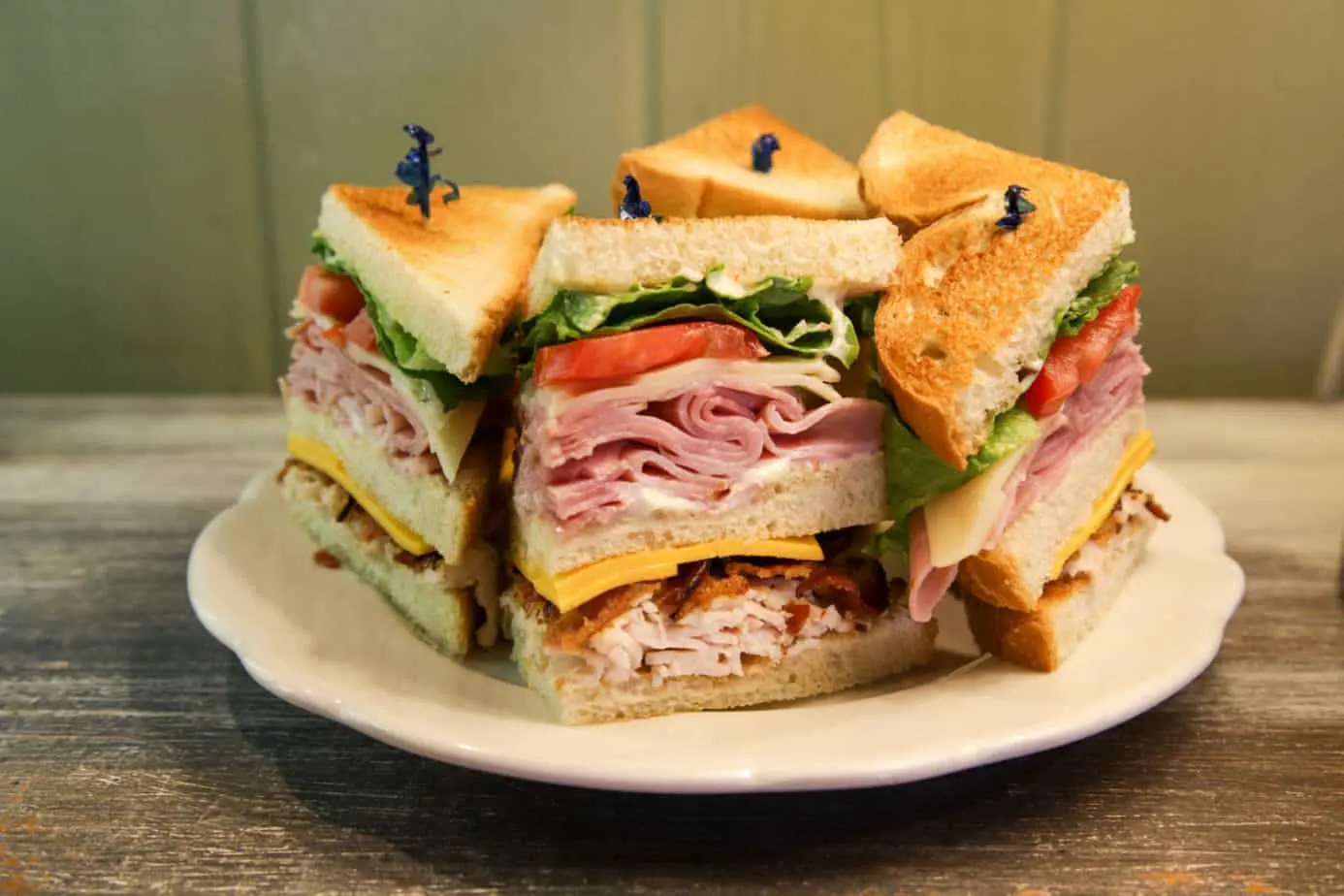 Club sandwich stacked with ham, turkey, bacon and cheese
